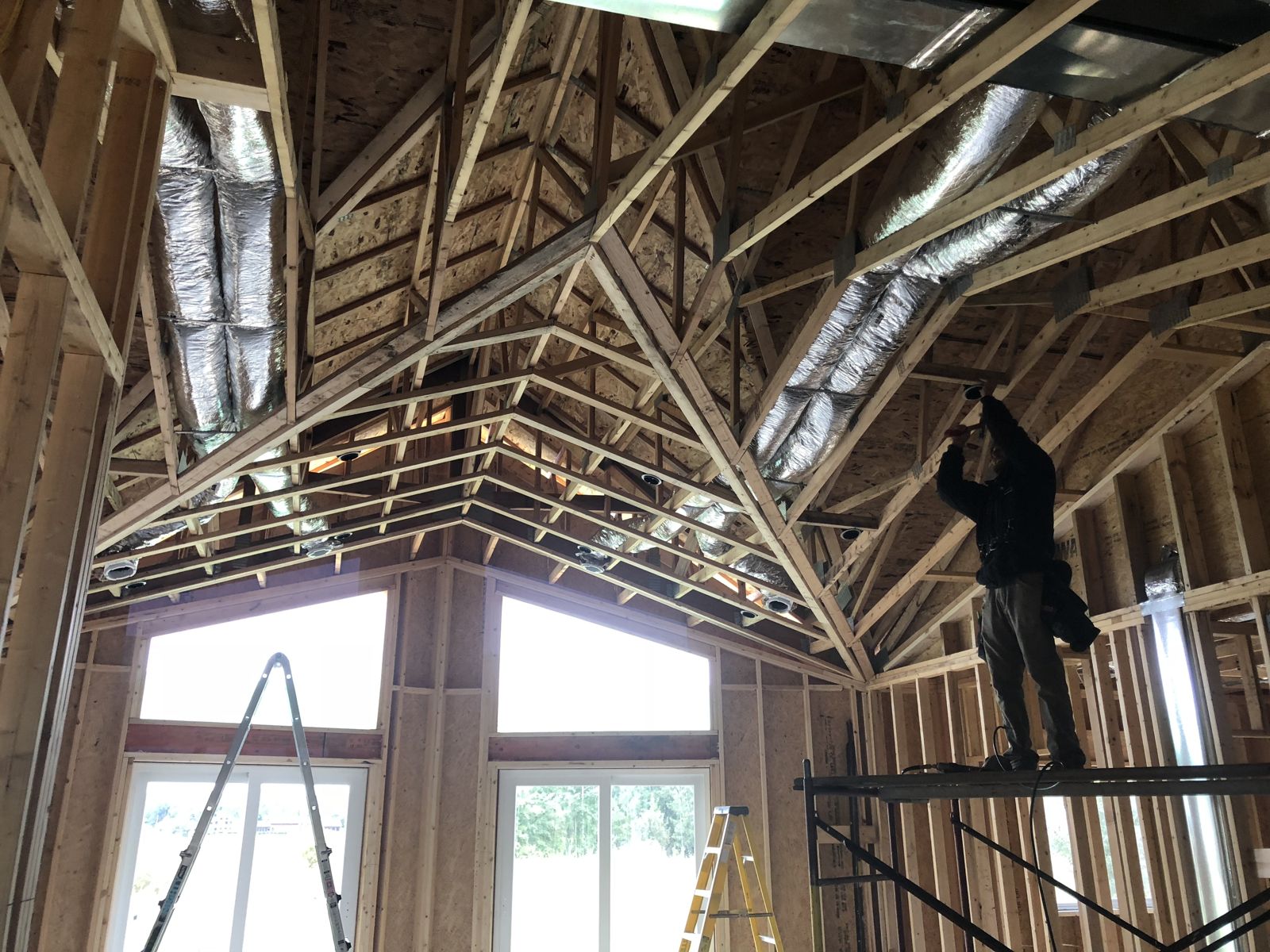 Jake framing the vaulted ceiling to prepare it for sheetrock while building our home