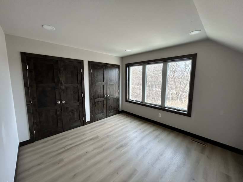 One of the two finished bonus room bedrooms in St. Cloud, MN, with a view over the lake