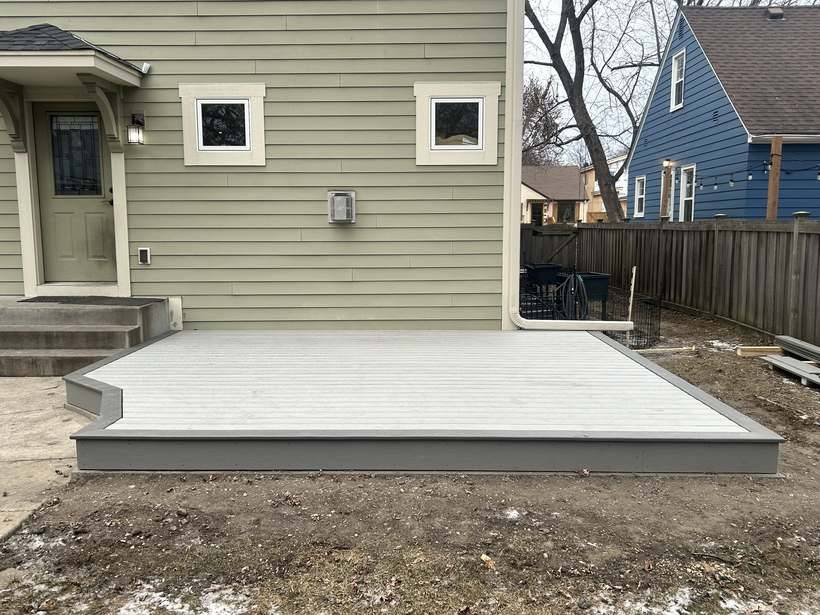 The finished deck seen from the yard alongside the house
