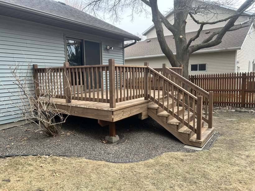 Deck resurfacing in Sartell, MN, finished with new decking and railing