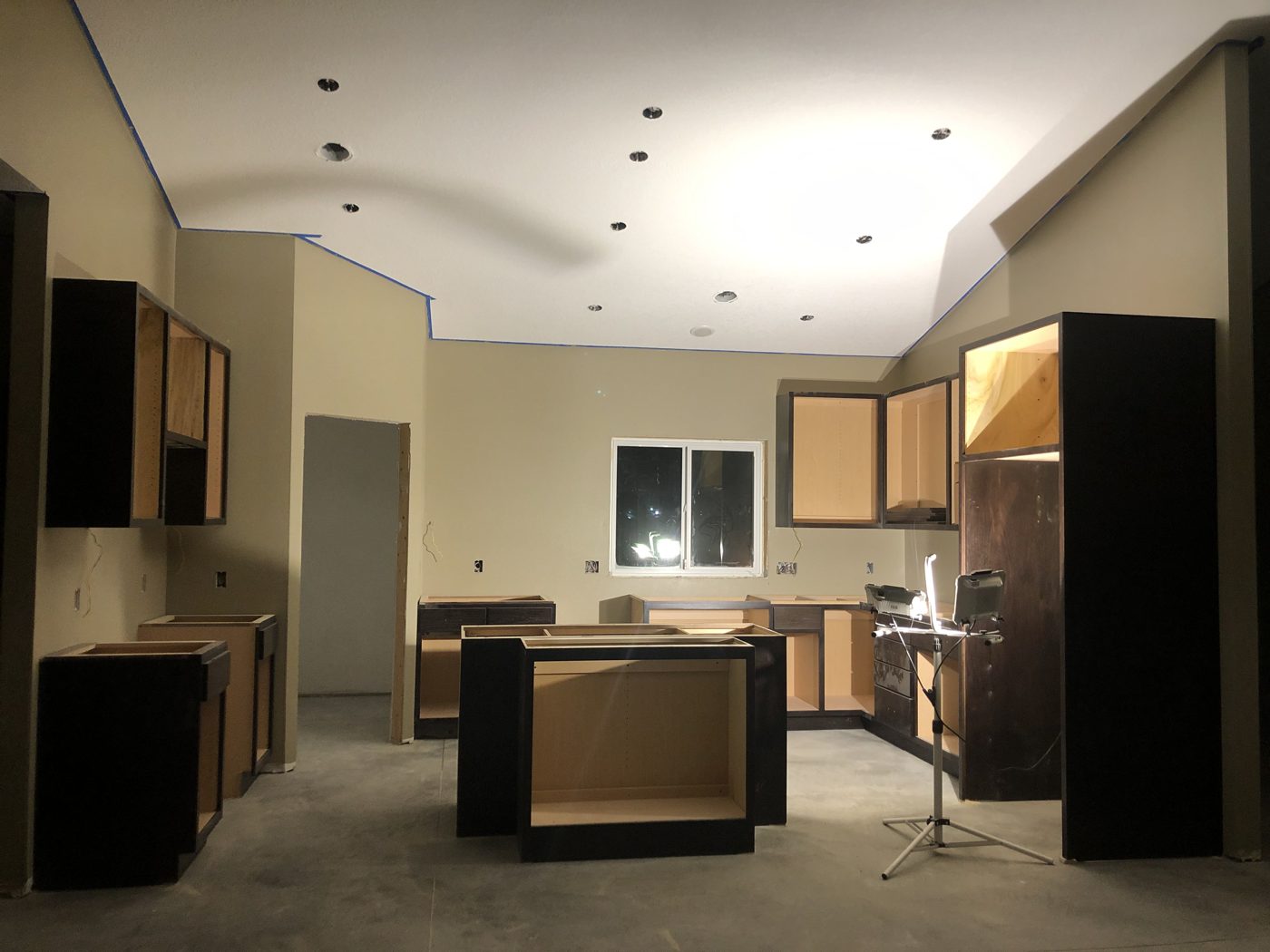 Cabinets being installed in the new St. Cloud, MN kitchen under the vaulted ceiling