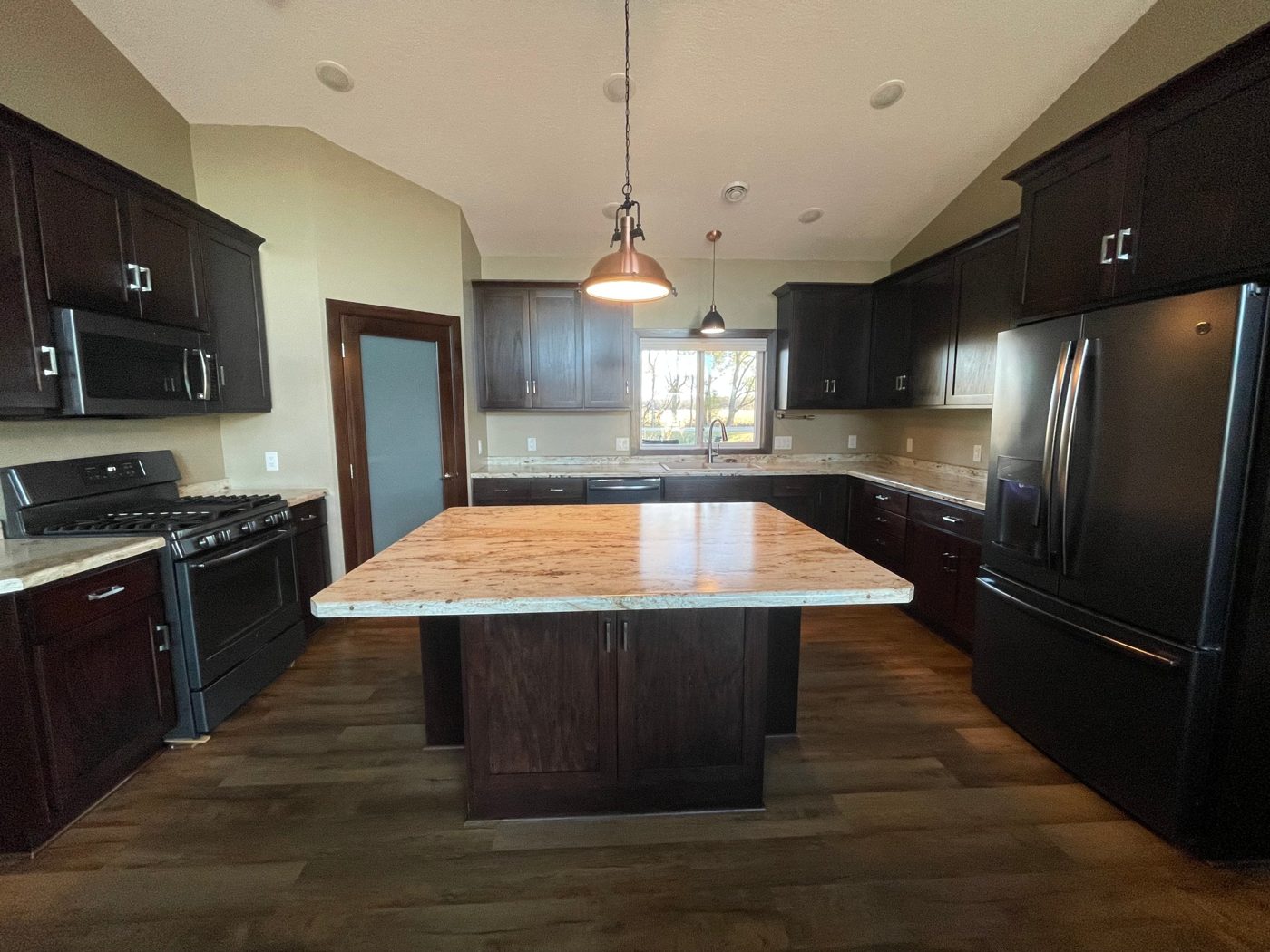 The finished kitchen with the refrigerator set into a full height cabinet surround