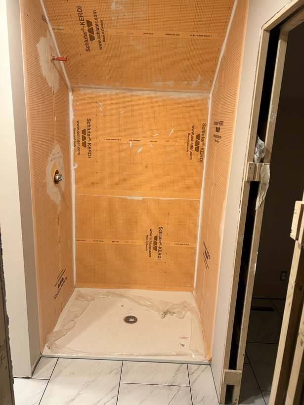 Waterproofing membrane installed before the shower surround went in