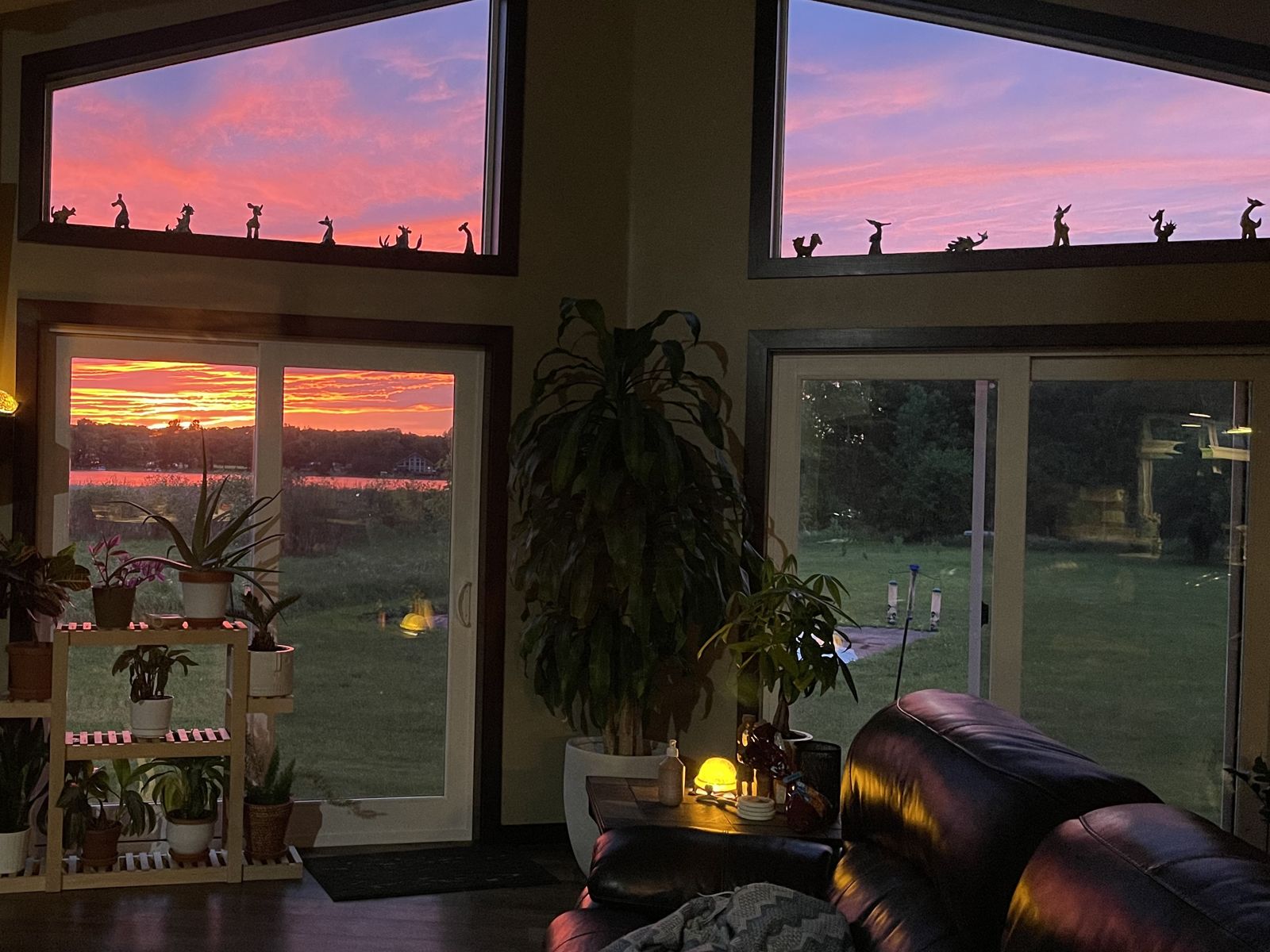 The same lake sunset seen through the living room windows of our finished home